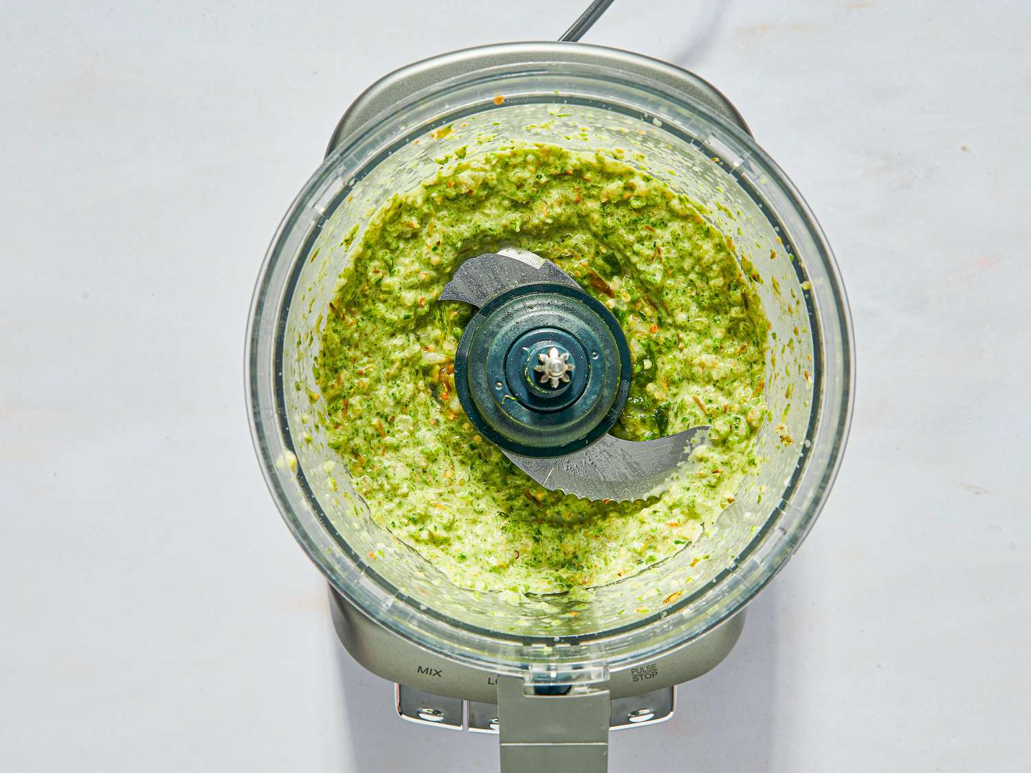 Overhead view of sauce pulsed in food processor bowl