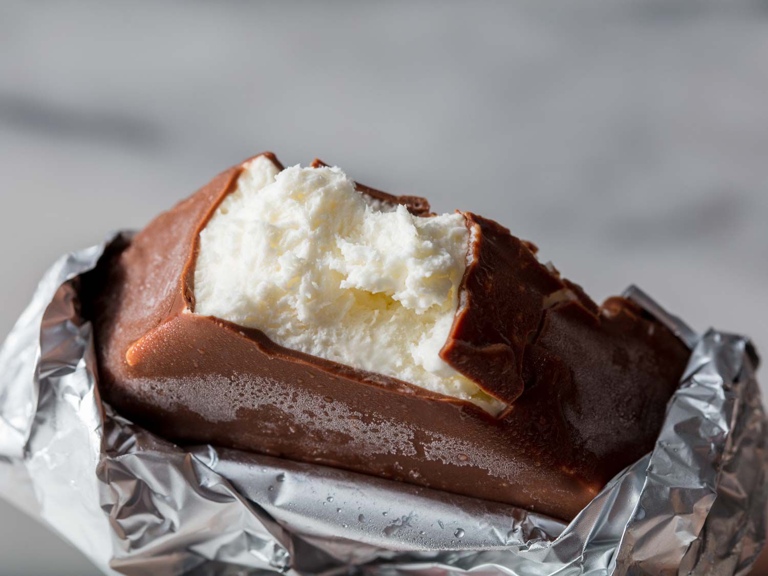 A homemade Klondike Bar with a bite taken out of it.