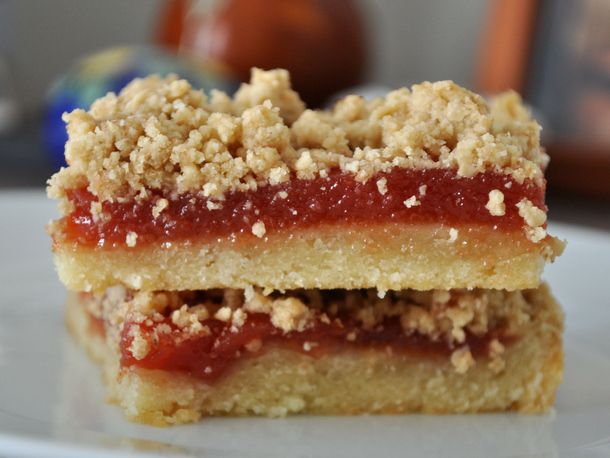 Close up side view of guava bars on a plate. 