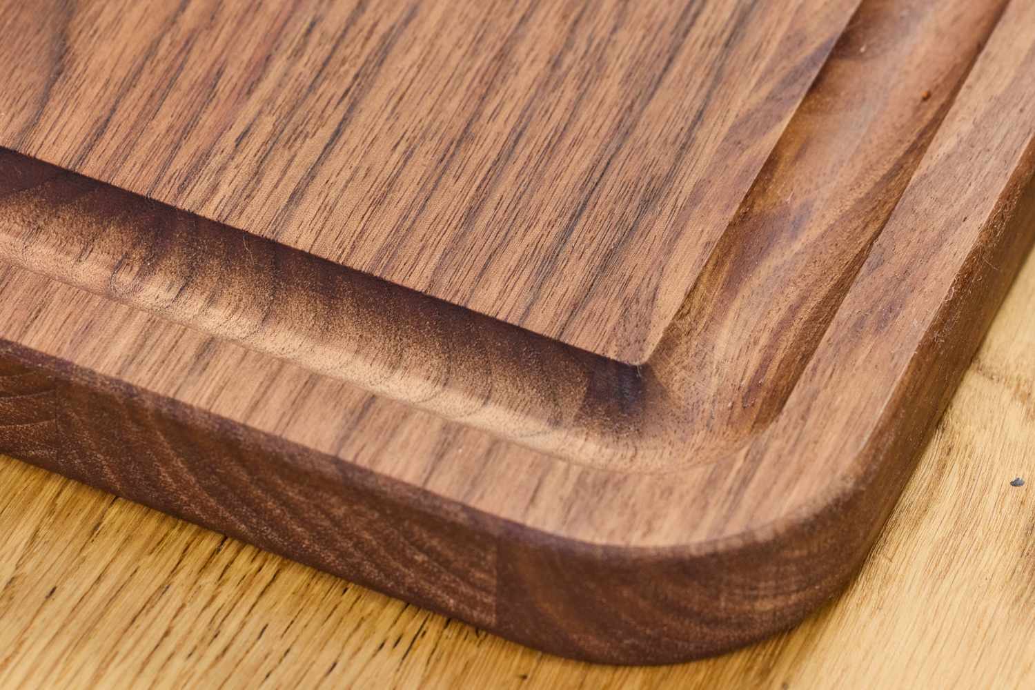 Closeup view of the corner of a Virginia Boys Kitchens Walnut Wood Cutting Board