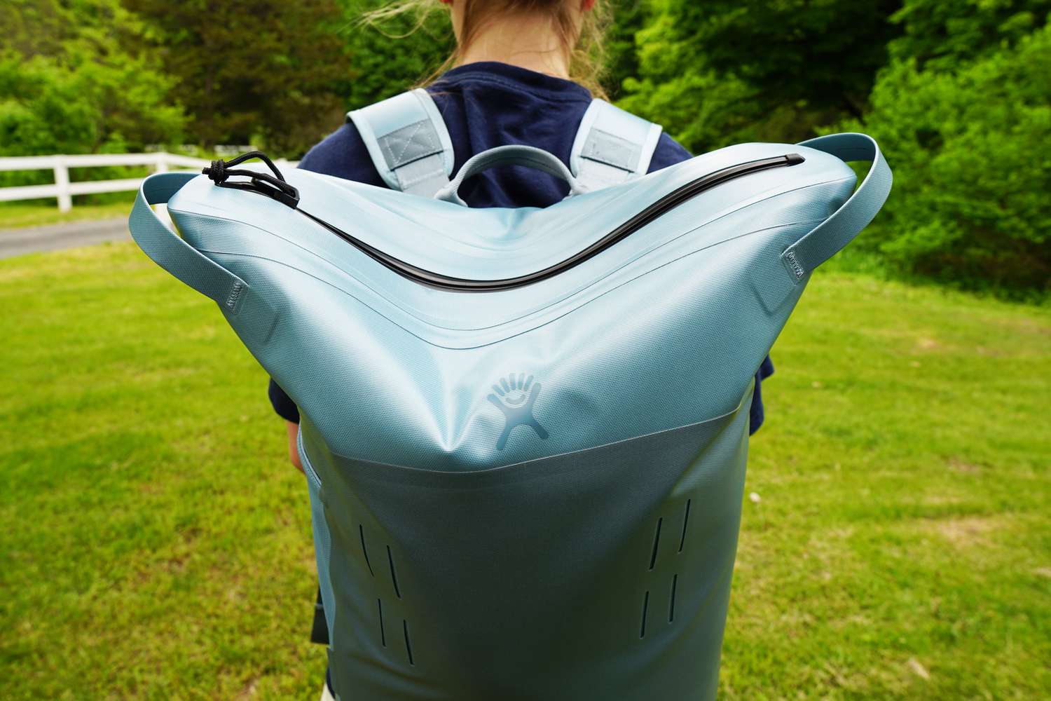 a person with a backpack soft cooler on their back