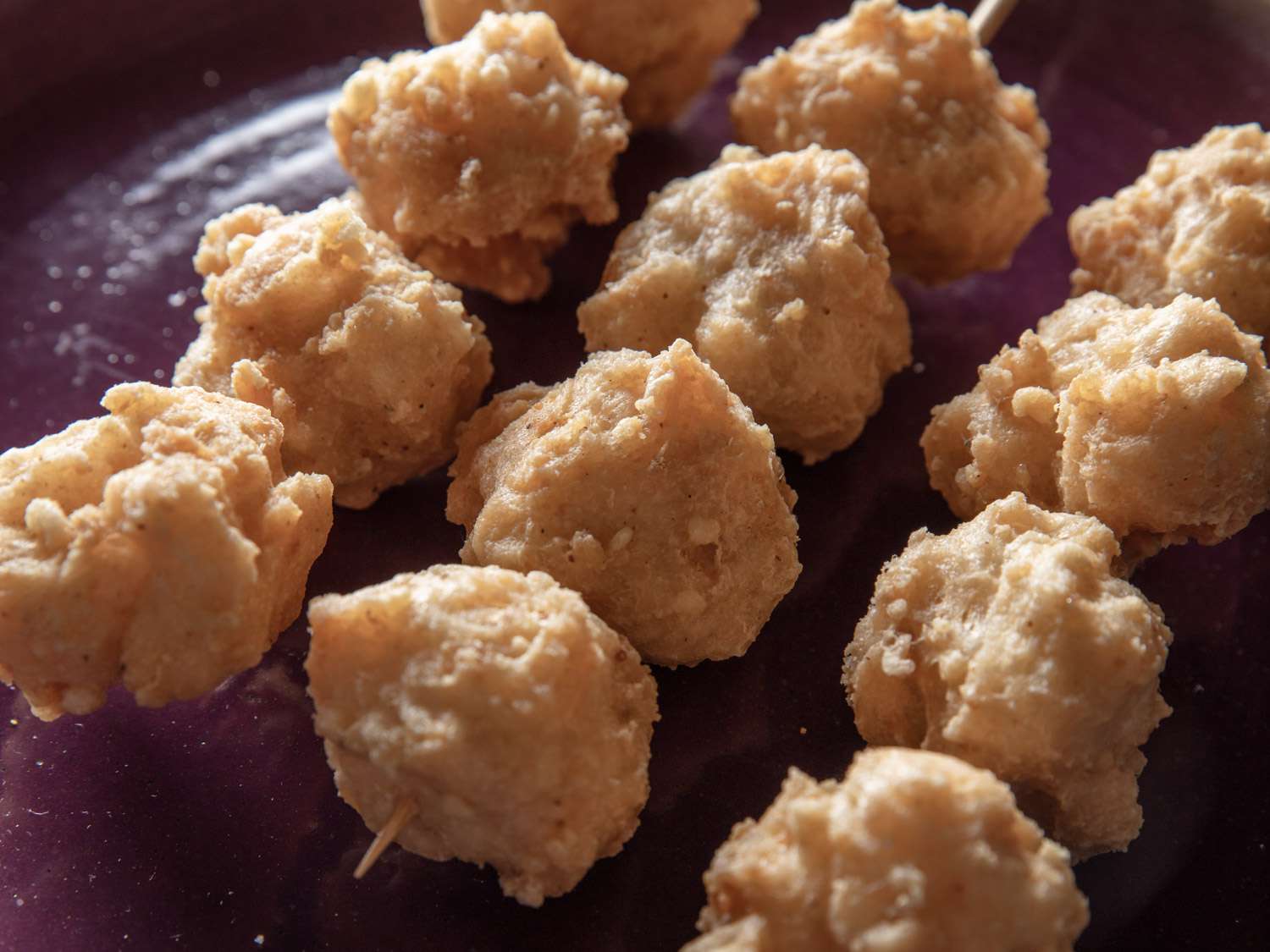 Close up image of finished squid balls on skewers.