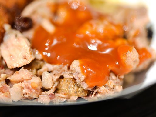 Closeup of barbecue smothered with peach-bourbon barbecue sauce.