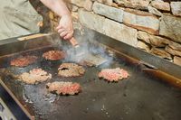 Smashburgers are made on the Blackstone 1554 Cooking 4 Burner Flat Top Gas Grill