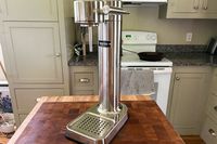 The Aarke soda maker on a wooden butcher block