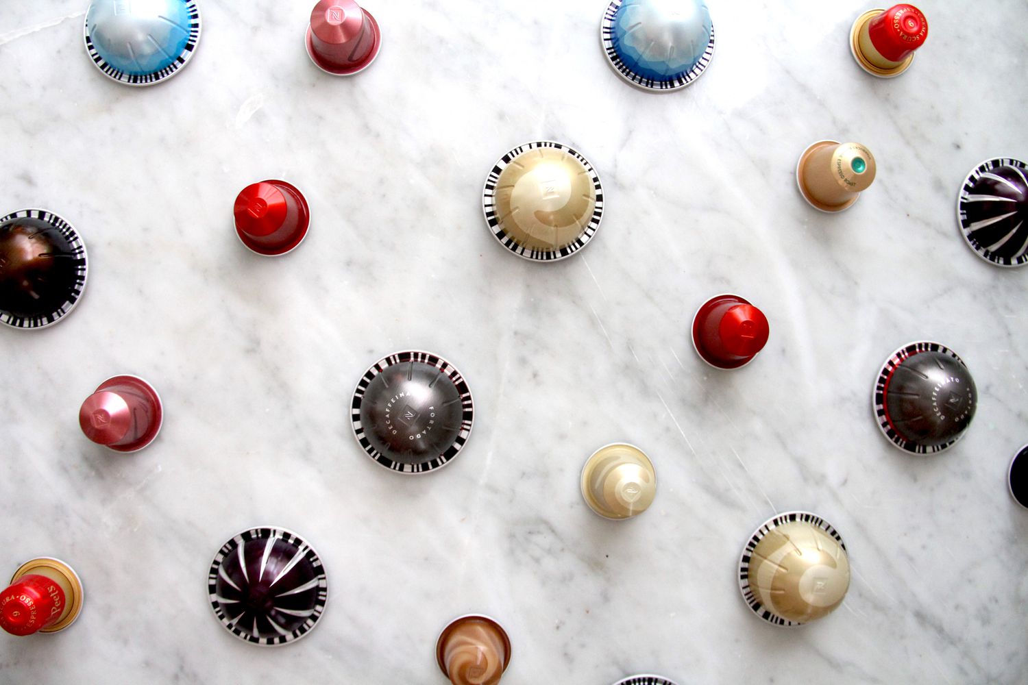 Nespresso pods on a marble countertop.