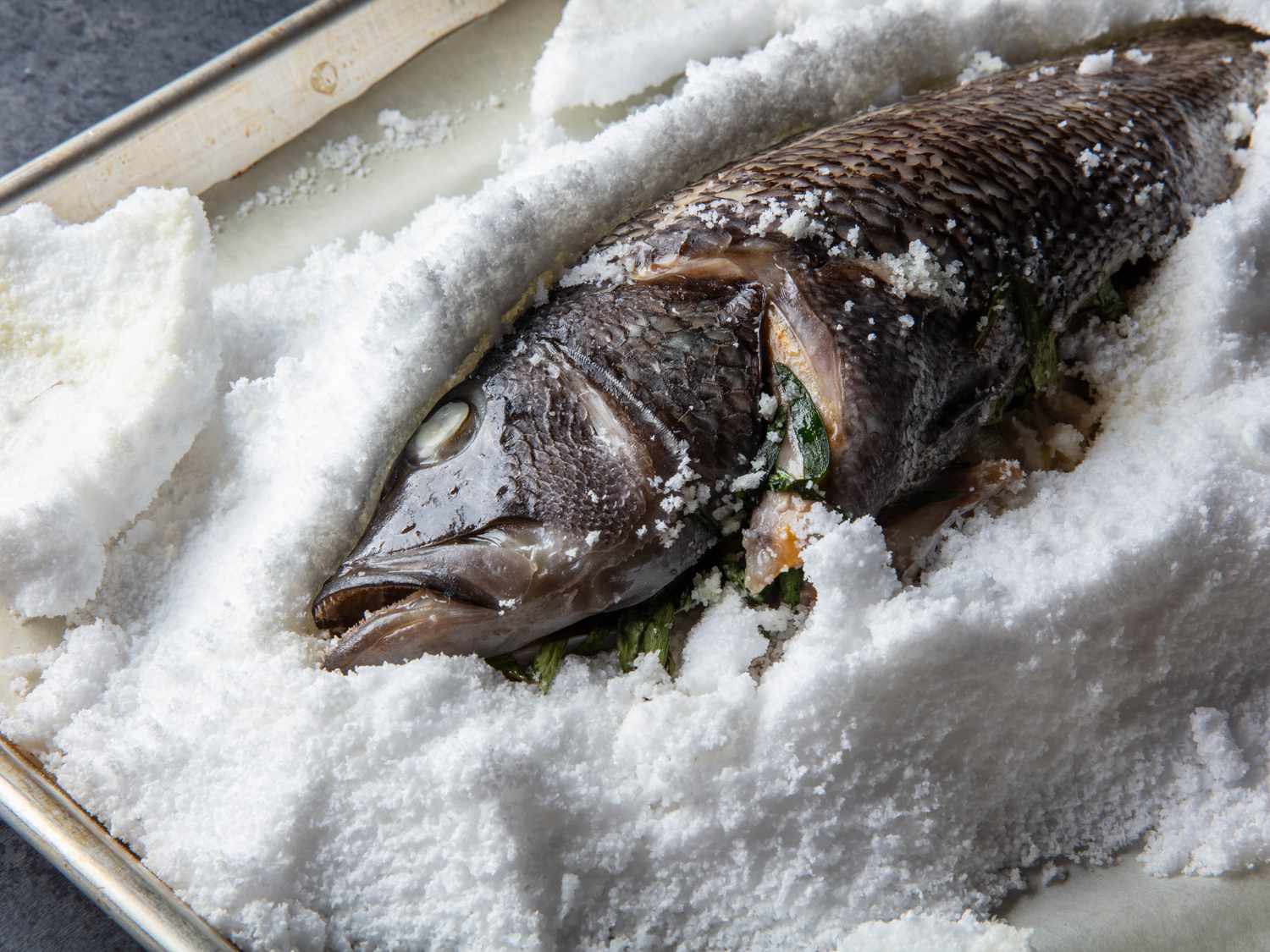 The excavated fish after cooking, with its skin intact.