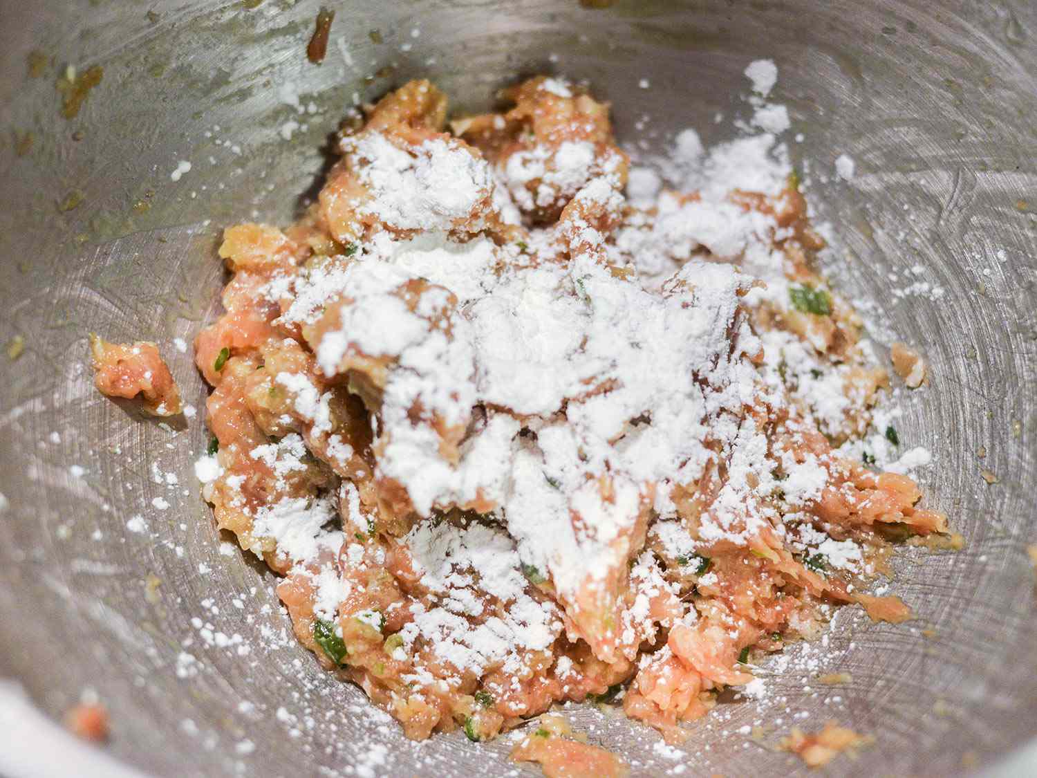 Cornstarch is added to the tsukune mixture.