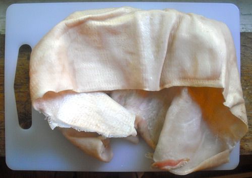 Pig skin on a cutting board. 