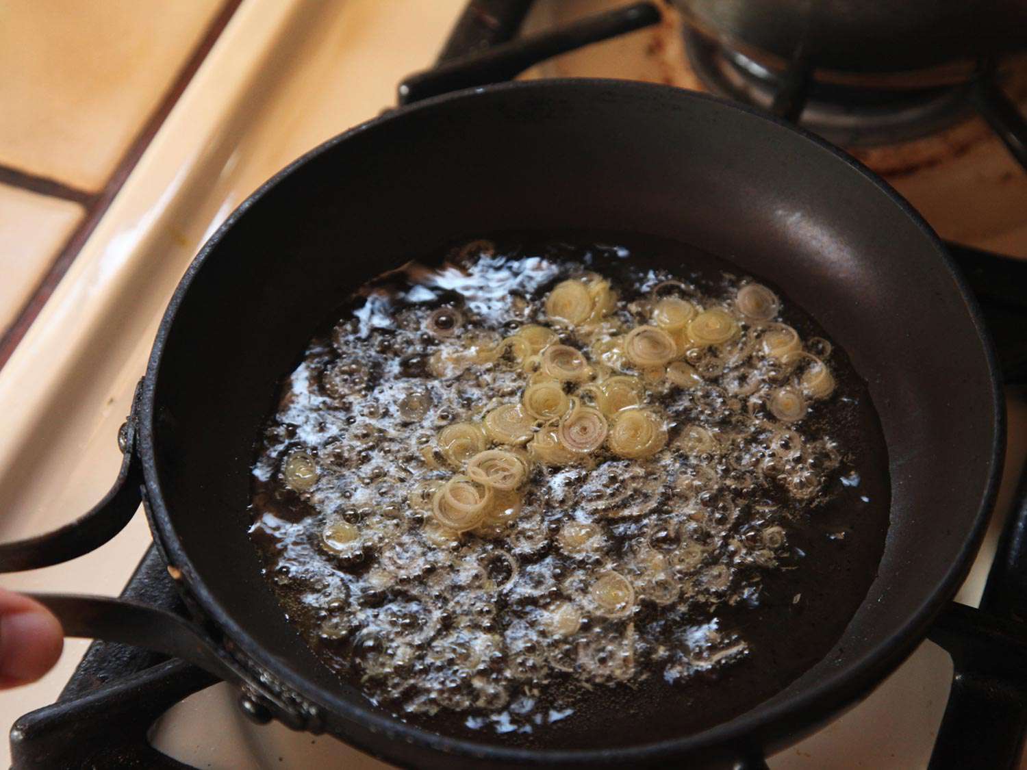 Frying lemongrass in a pan. 