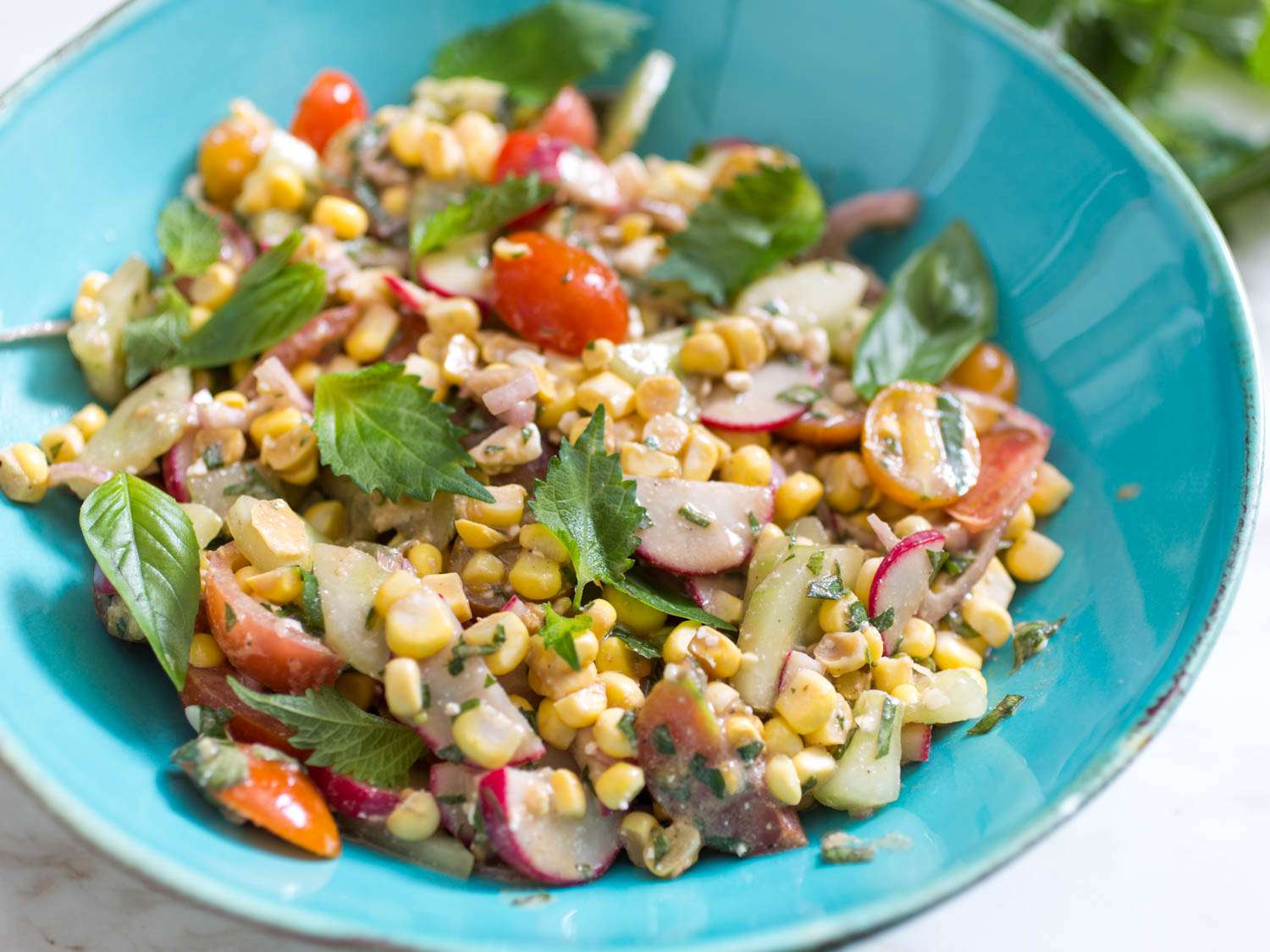 Corn salad in a blue bowl.