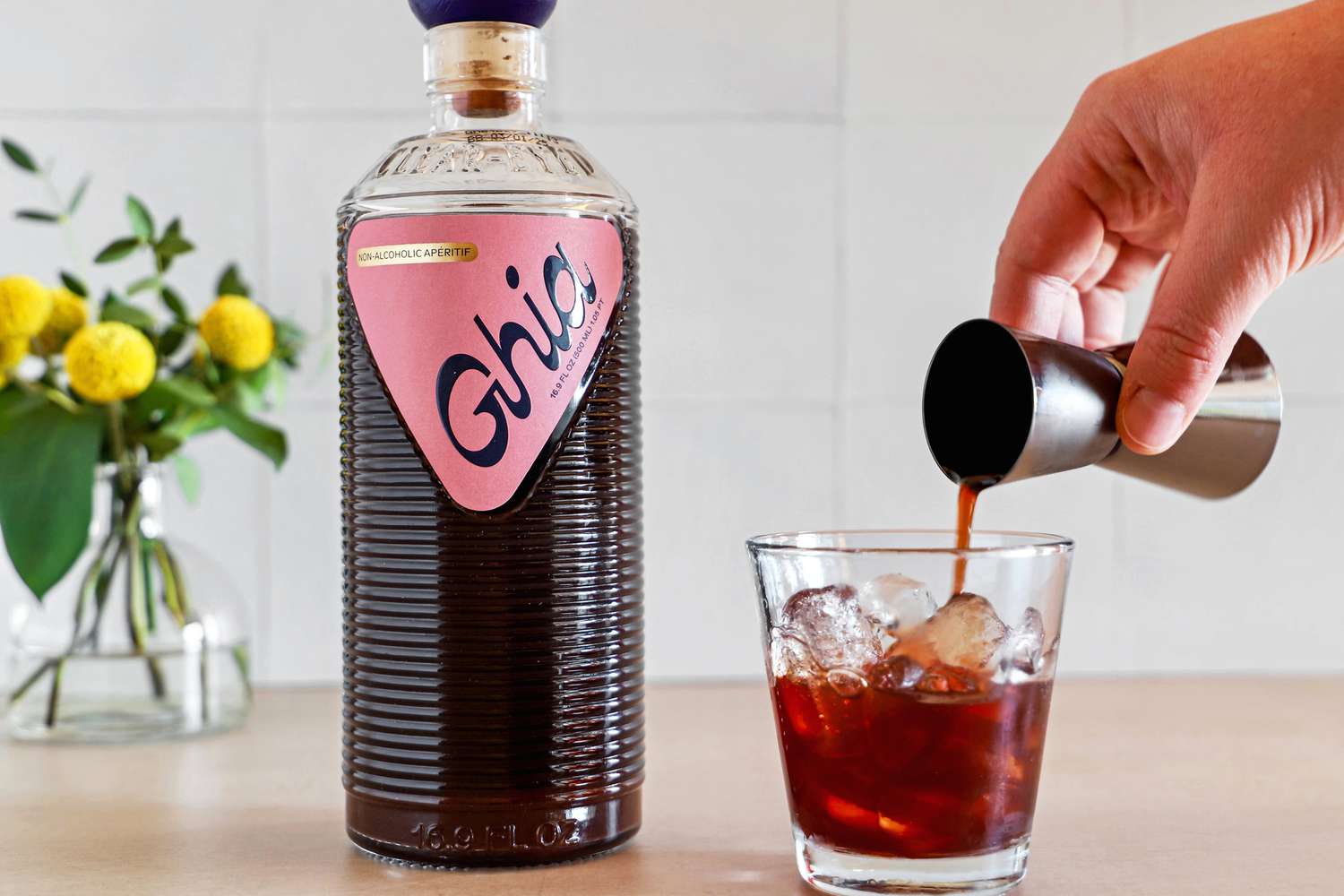 person pouring Ghia Nonalcoholic Apéritif