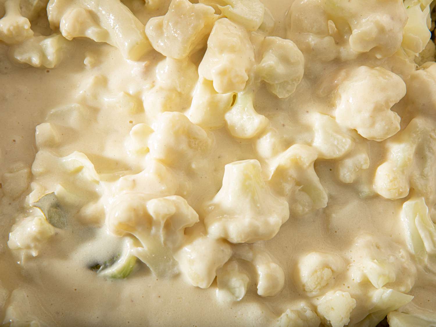 Overhead view of cauliflower covered in sauce