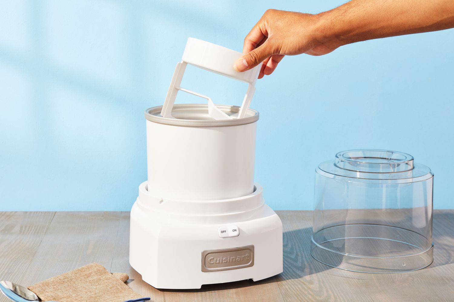 Hand removing dasher from Cuisinart 1.5-Quart Frozen Yogurt, Ice Cream, & Sorbet Maker