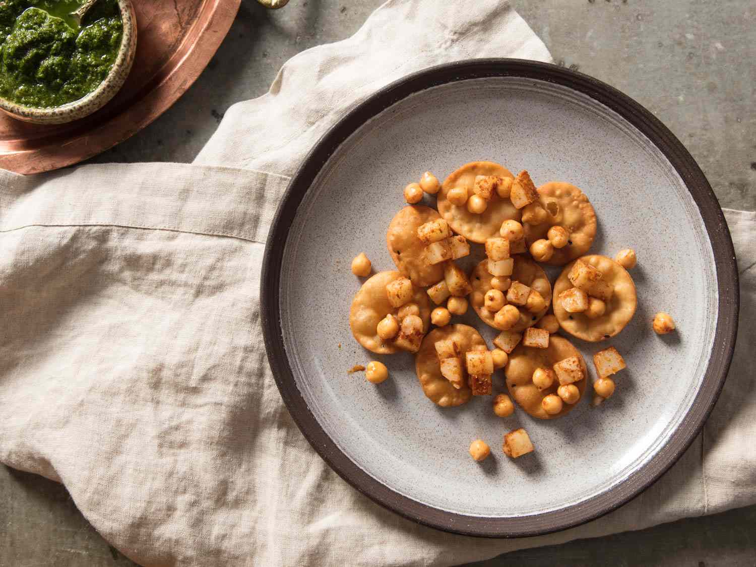 Papris topped with potatoes and chickpeas dusted in spices.