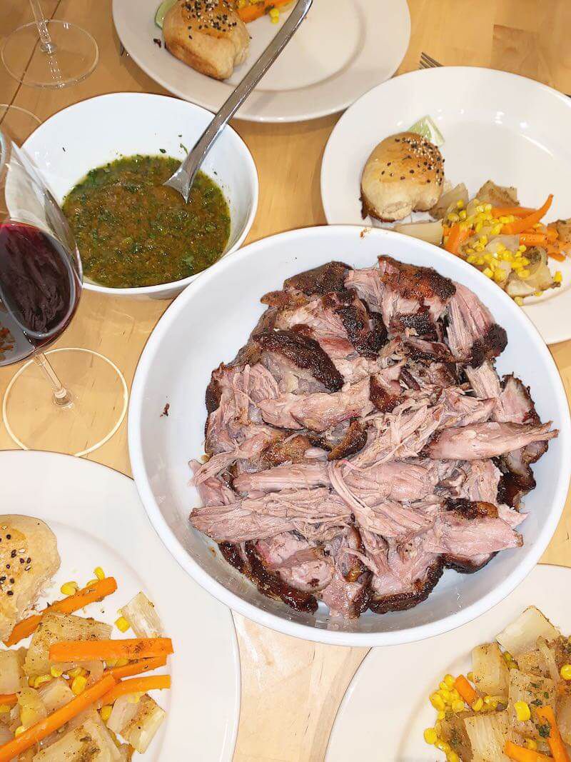 Overhead view of shredded cuban-style marinated and roasted pork with fixings alongside