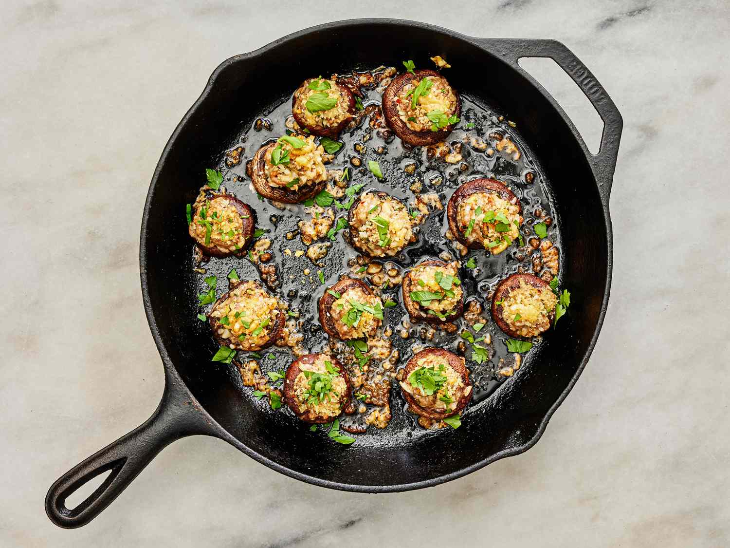 Cooked mushrooms garnished with parsley in skillet 