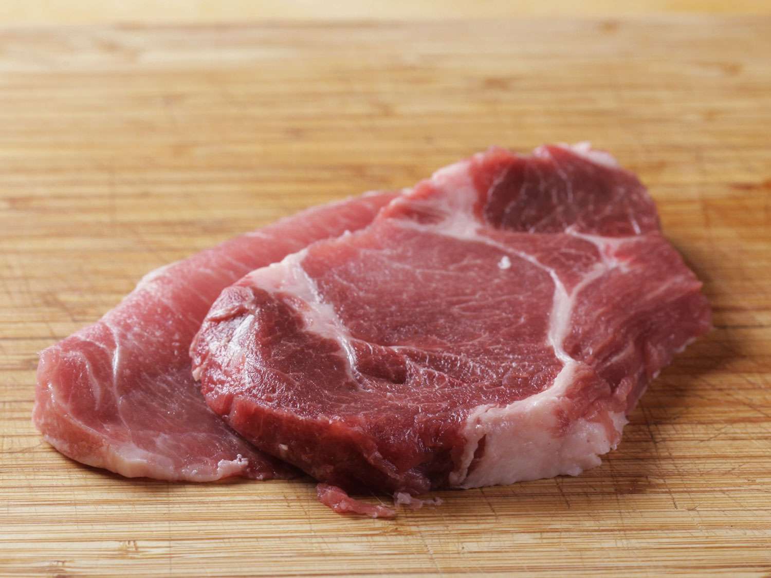 Two raw pork sirloin cutlets for tonkatsu.