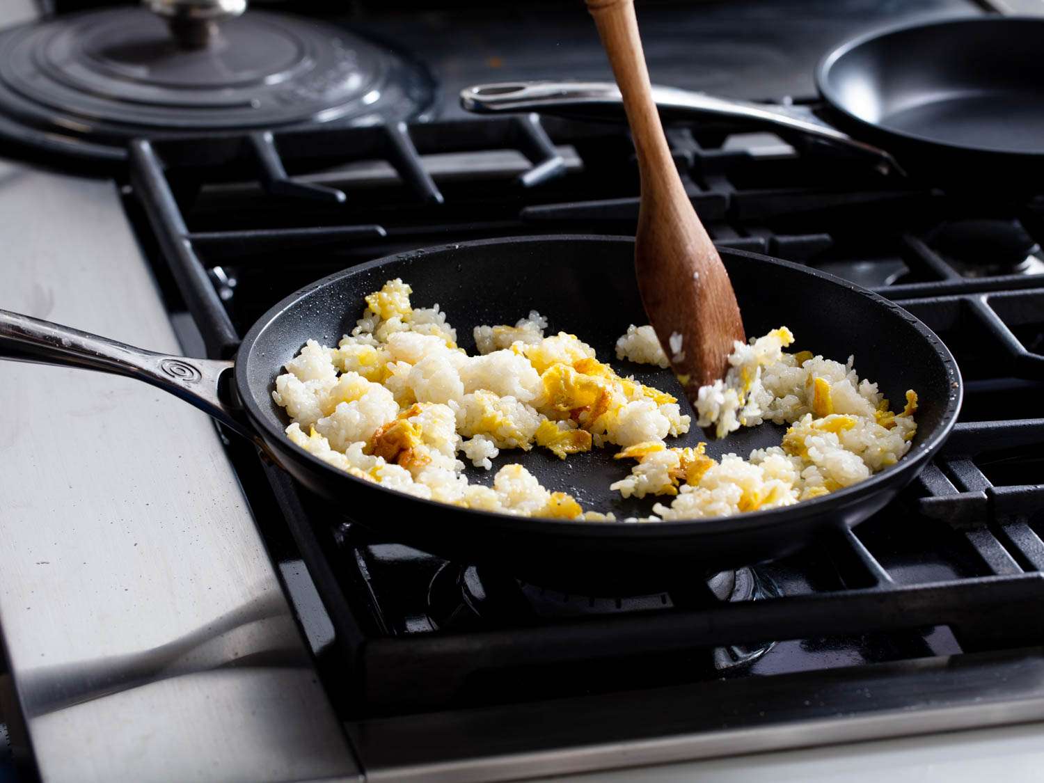 Cooked rice is added to pan and mixed with the scrambled egg.