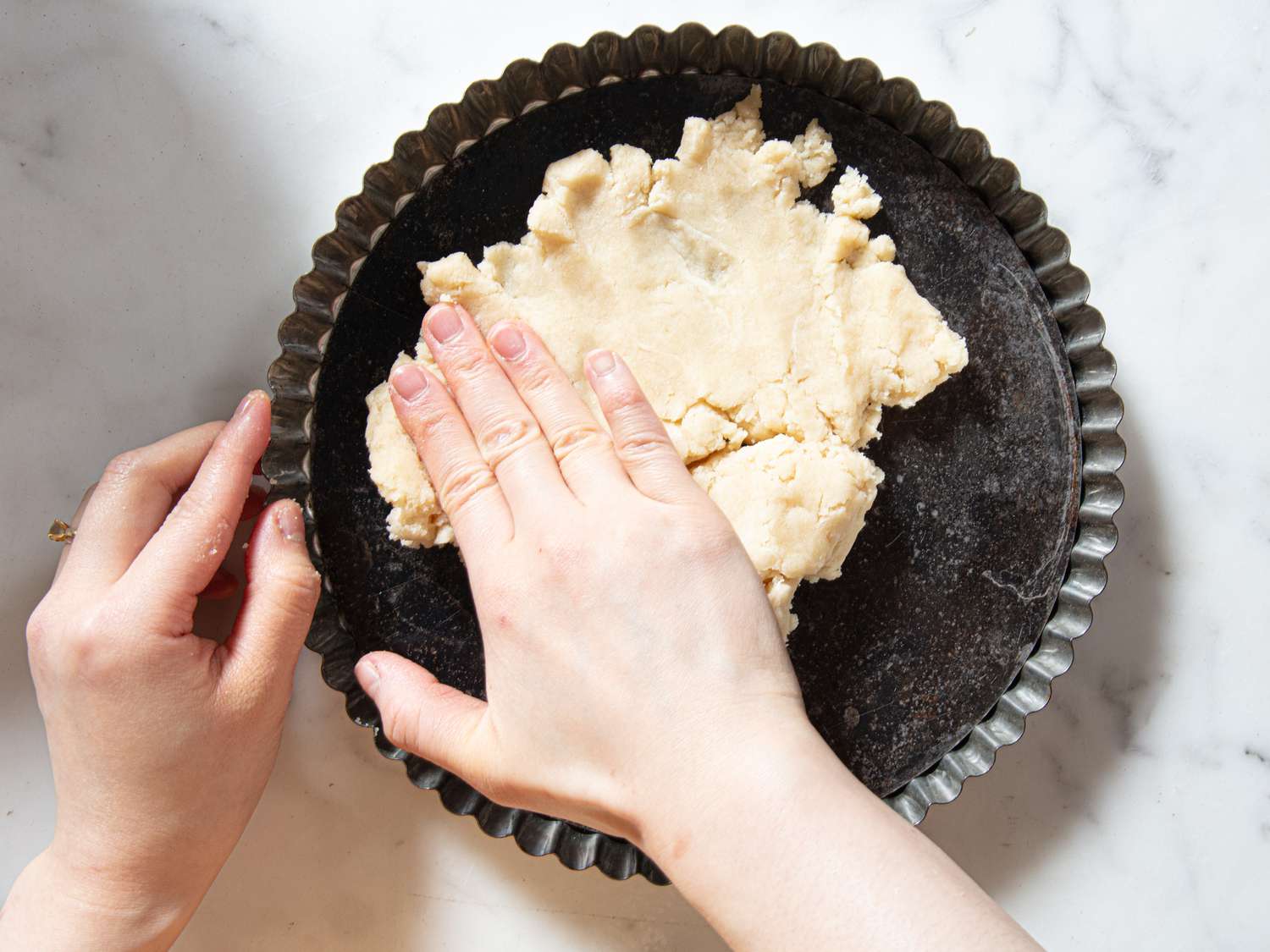 Overhead view of pressing dough pie
