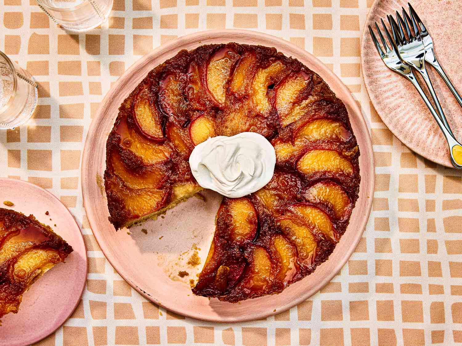 Overhead view of finished peach upside down cake with a slice removed