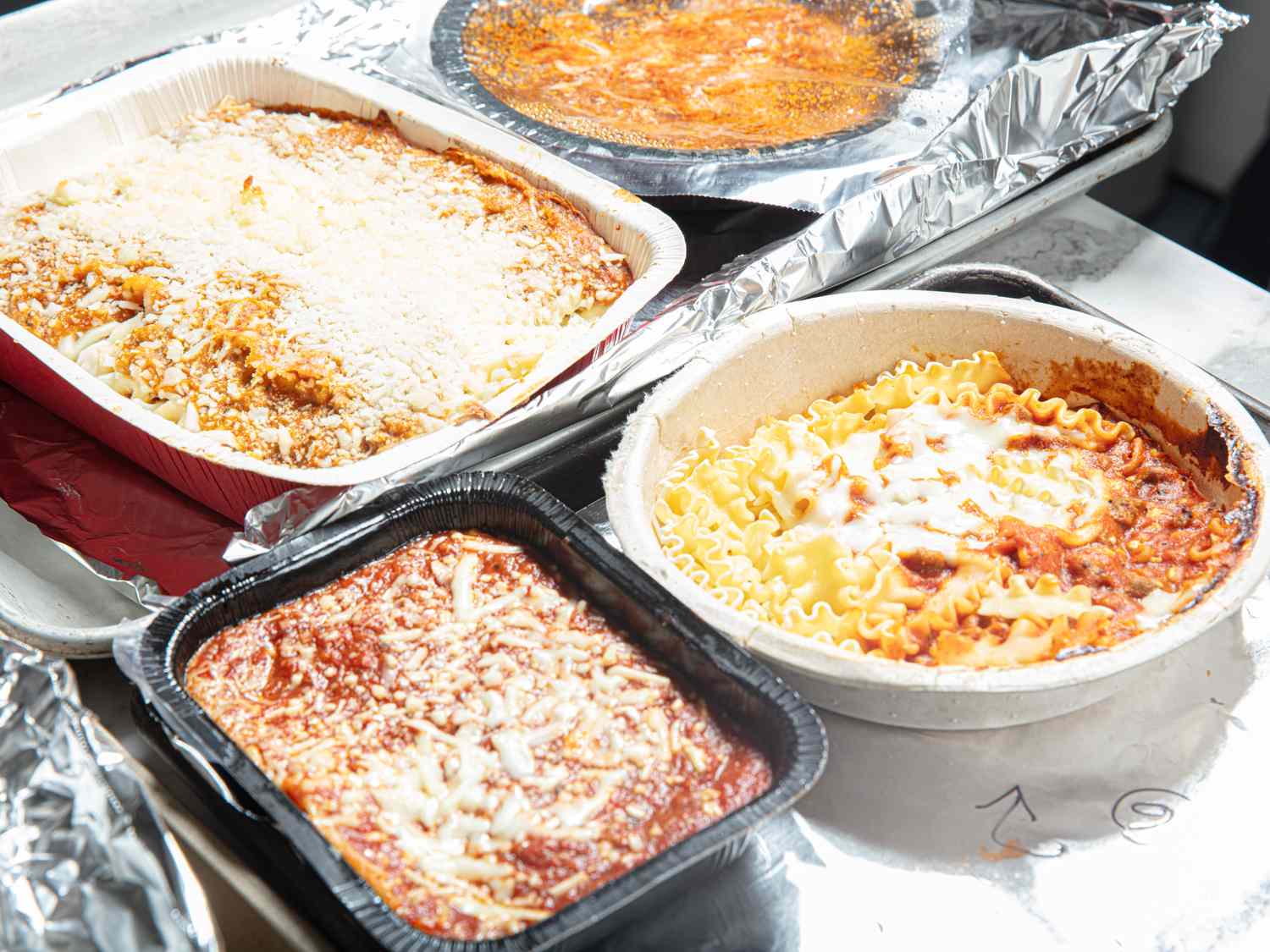 A variety of frozen lasagna dishes displayed in their trays