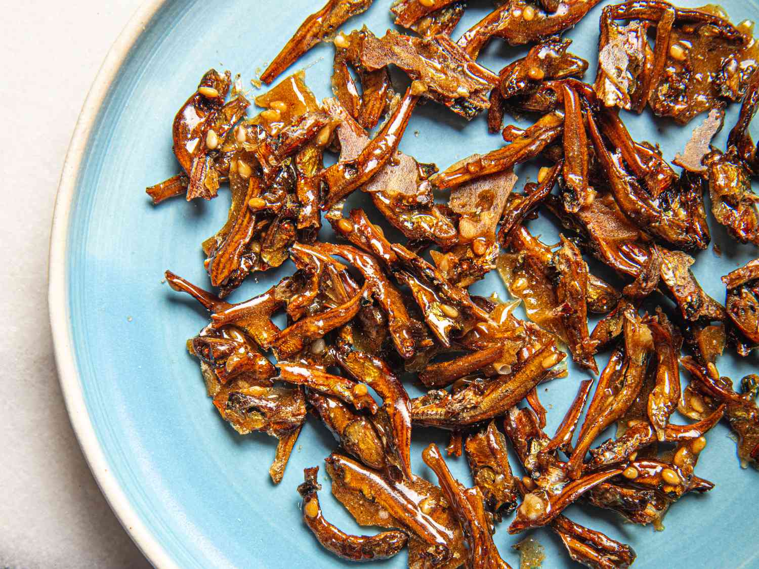 Overhead view of candied anchovies on a plate