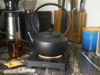 the balmuda kettle on its stand with a glowing light underneath it