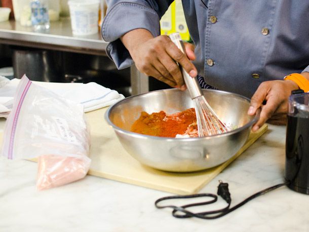 Chef Floyd Cardoz whisking a marinade together for butter chicken