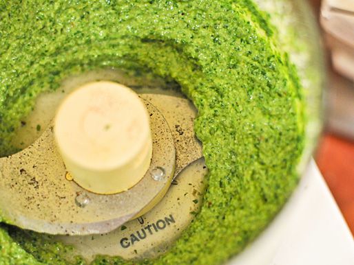 Closeup of the finished pesto in the food processor bowl.