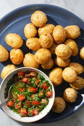 Fried papas criollas on a blue ceramic plate with ajÃ­.