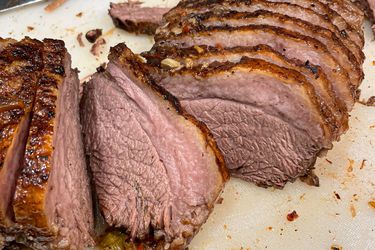 Sliced cooked beef roast presented on a cutting board