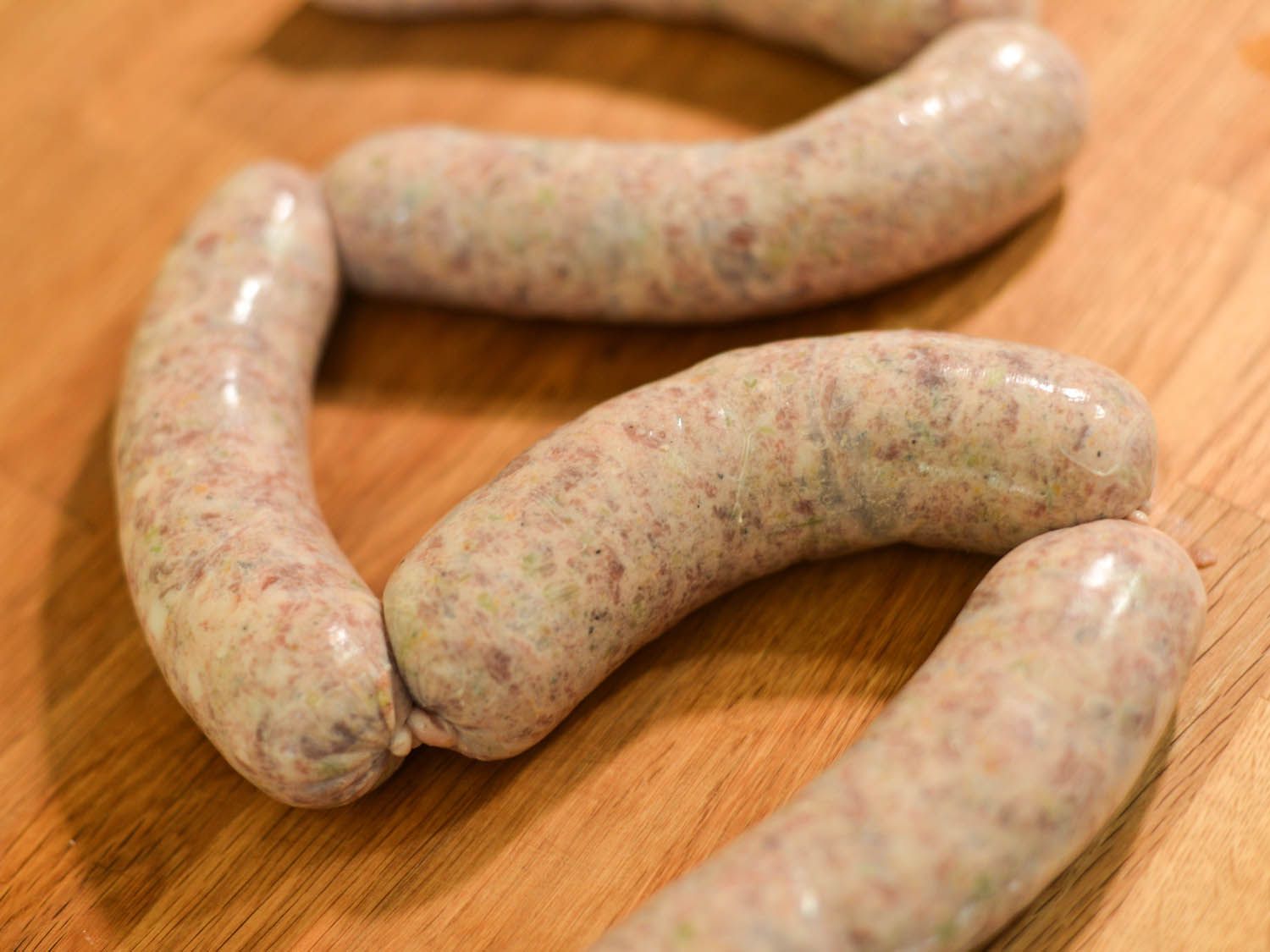 The stuffed casing is twisted into links.