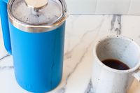 Yeti French Press next to a coffee mug