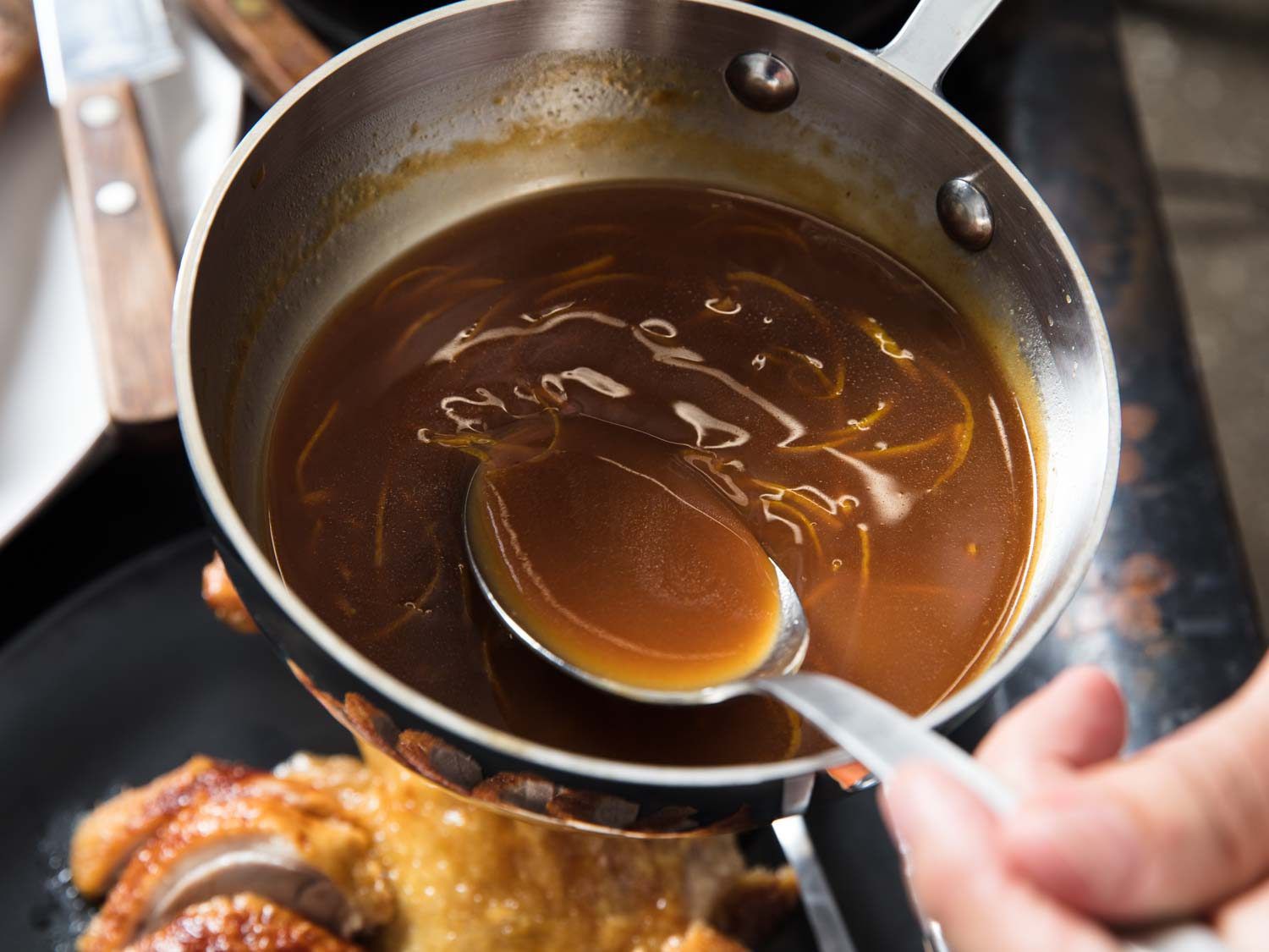 A saucepan of bigarade sauce for Duck à l'Orange