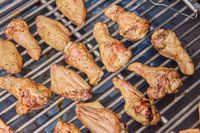 Chicken wings are cooked in the Yoder Smokers YS640S Pellet Grill