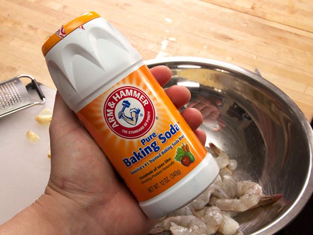 A container of baking soda, which helps maintain a crunchy texture in shrimp.