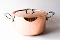 A metal cooking pot with handles and a lid