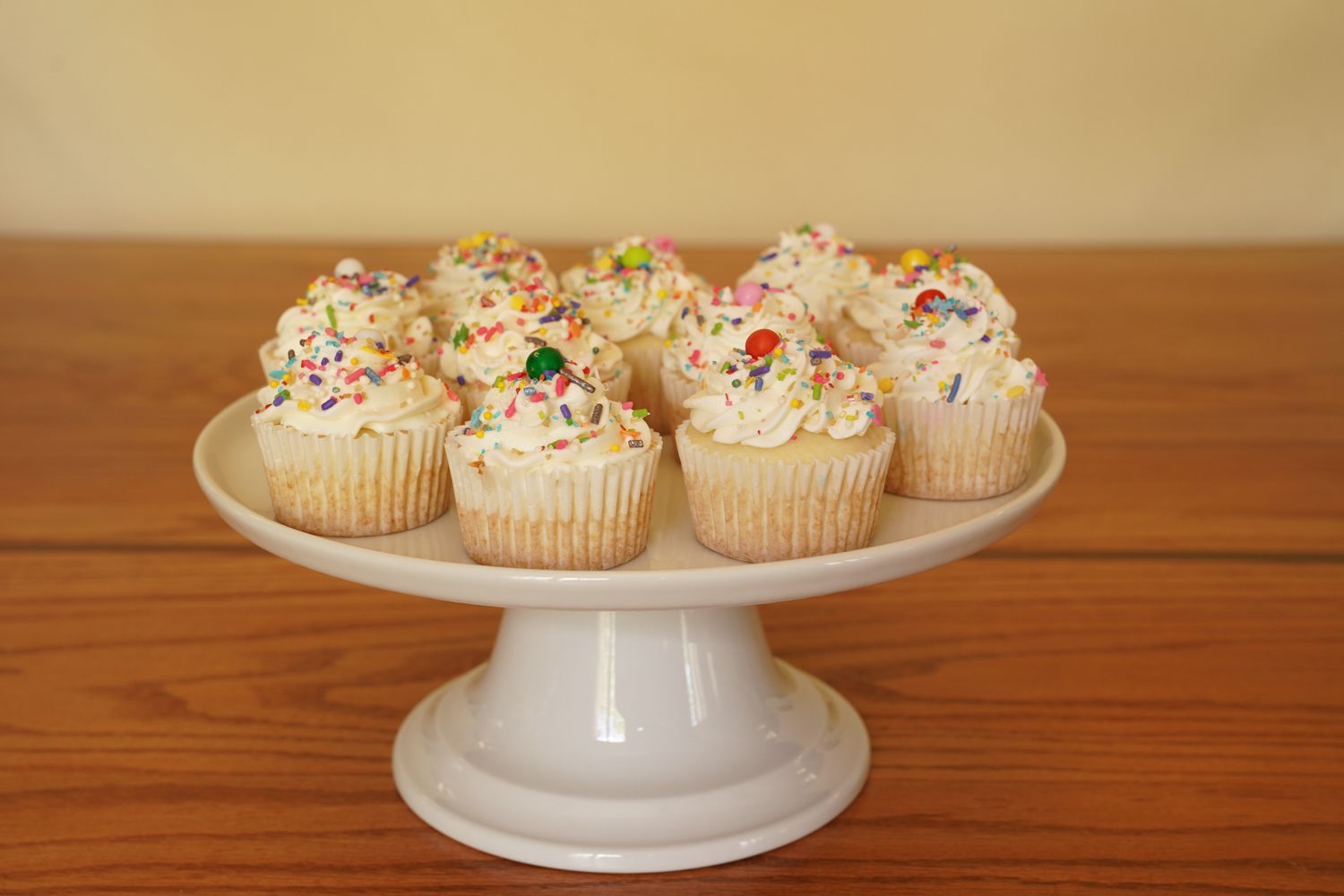 Cupcakes with frosting and sprinkles on a cake stand