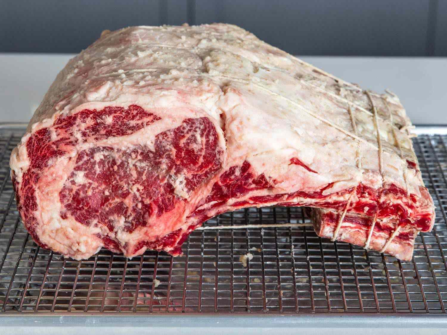 Shio koji-marinated prime rib on a wire rack-lined baking sheet.