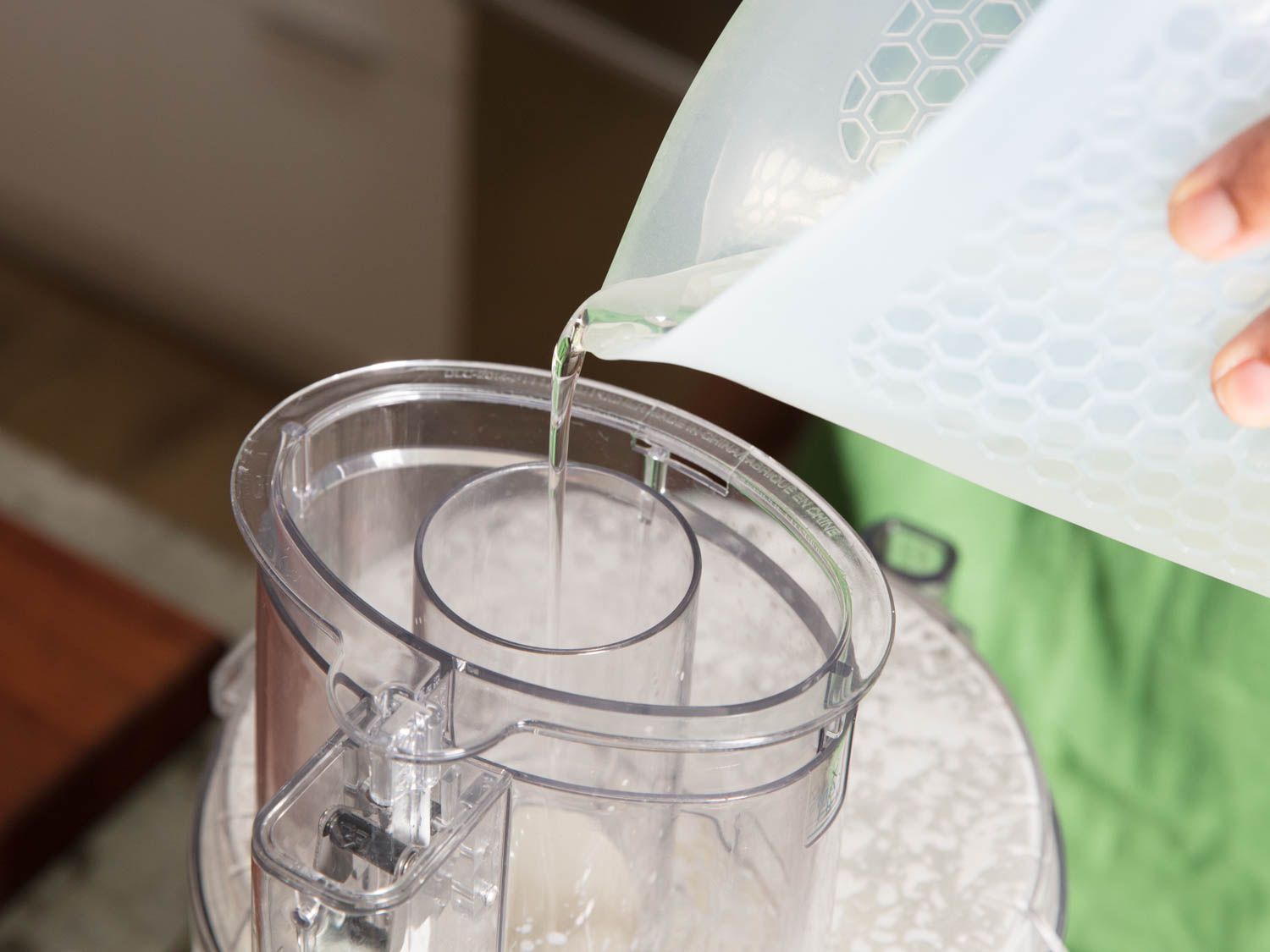 Oil pouring into a food processor