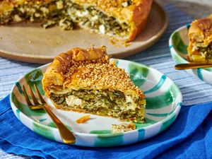 A slice of homemade phyllo dough pie on a plate with a fork