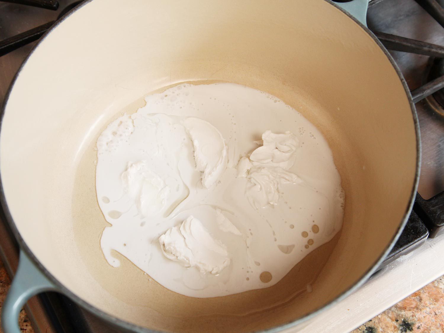 Melting coconut cream in a Dutch oven for peanut soup.