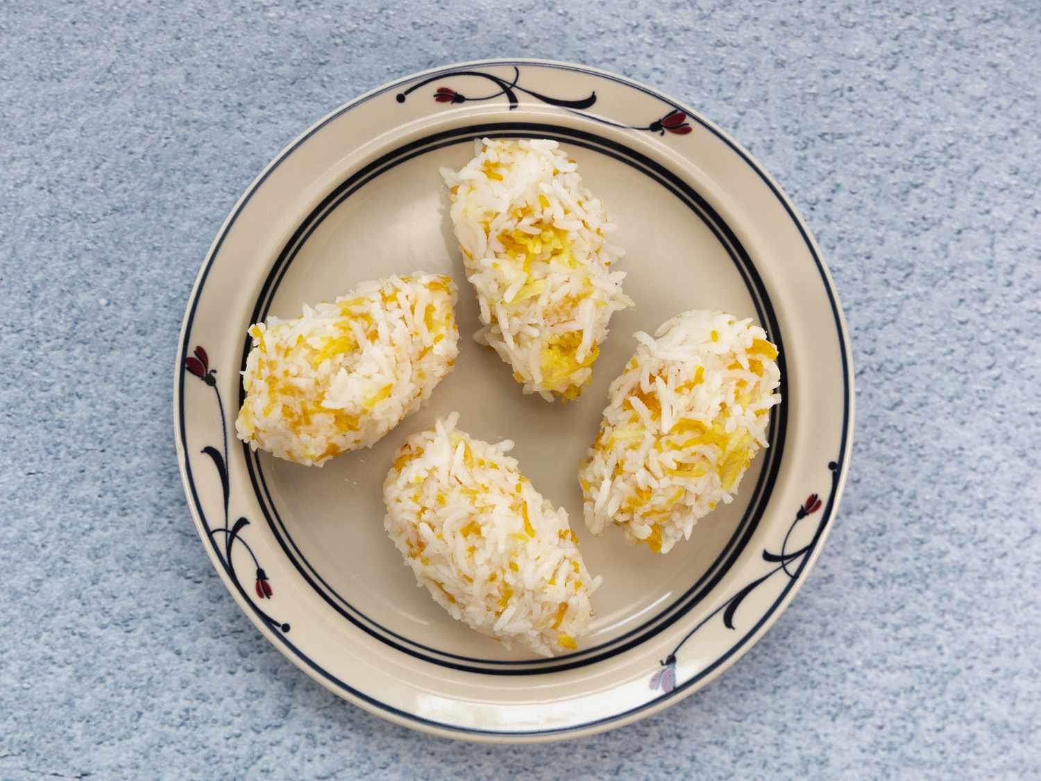 Overhead view of obolong shaped rice and tahdig cakes on a plate