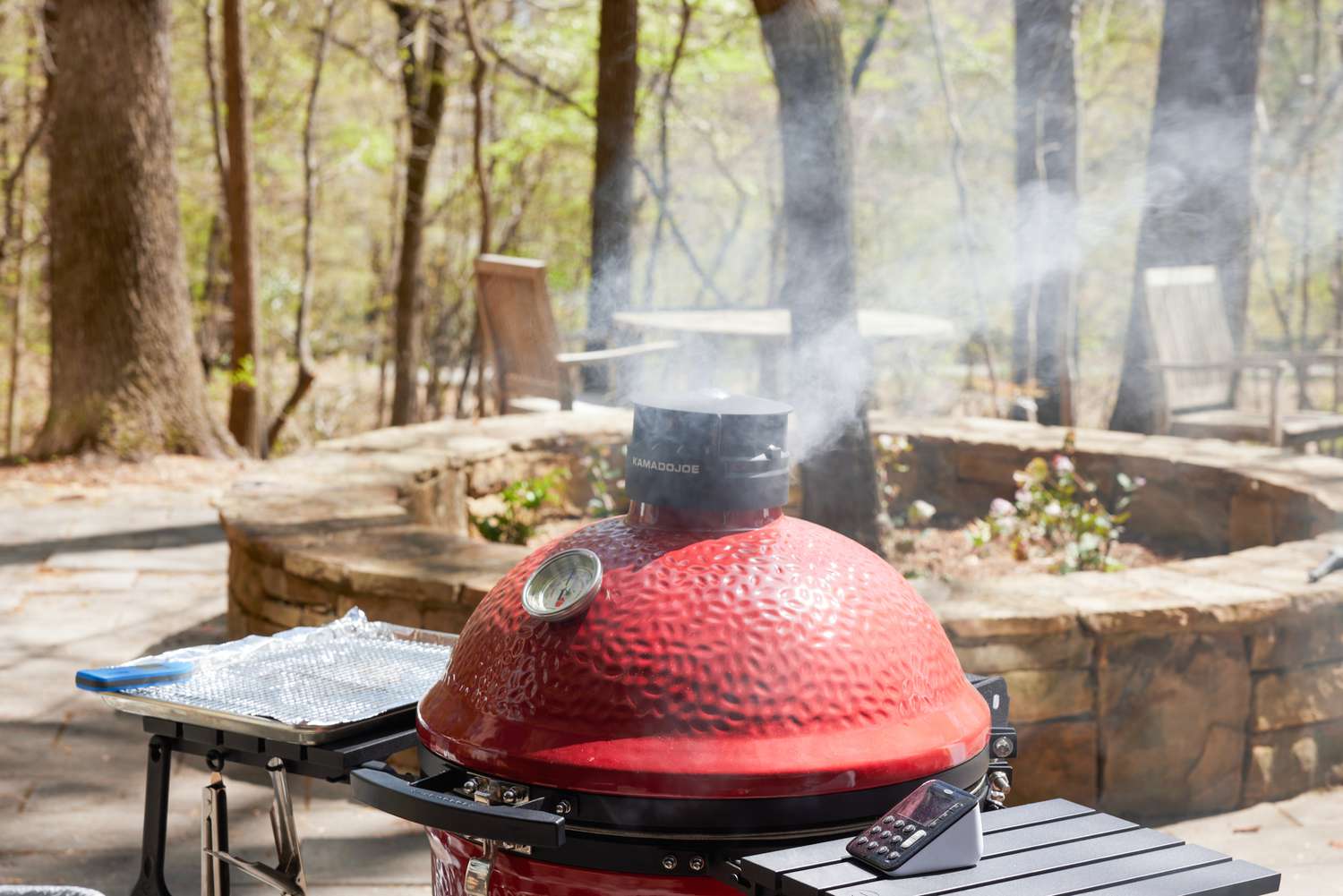 a shot of a kamado cooker billowing smoke
