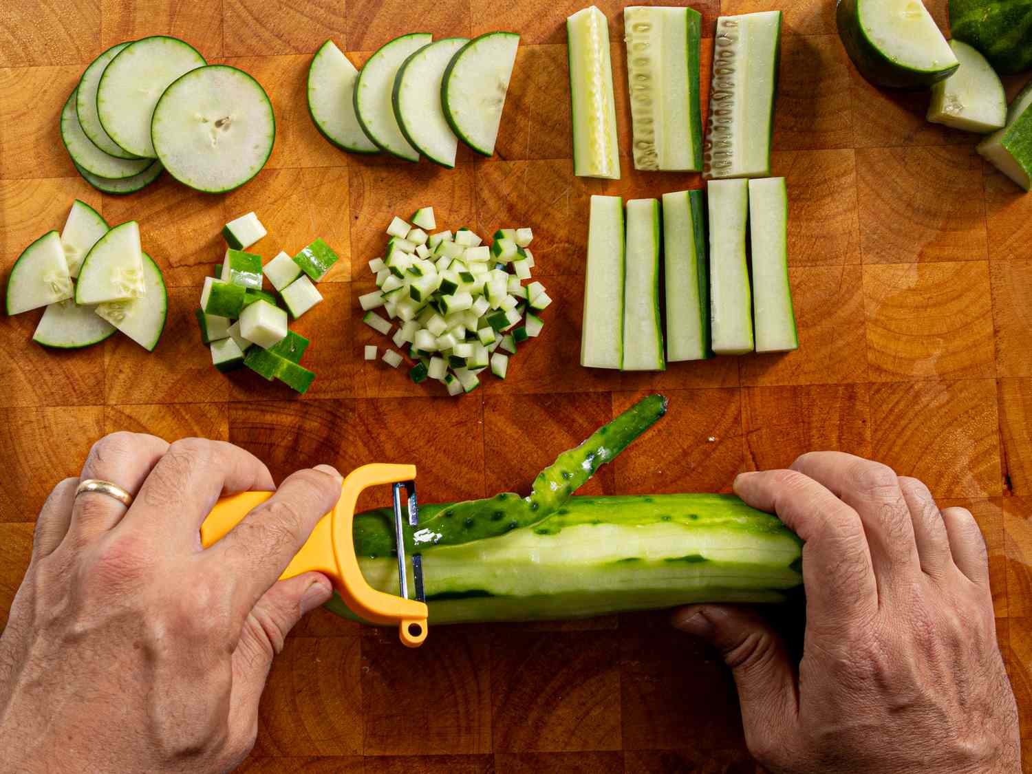 Overhead view of peeling a cucumber