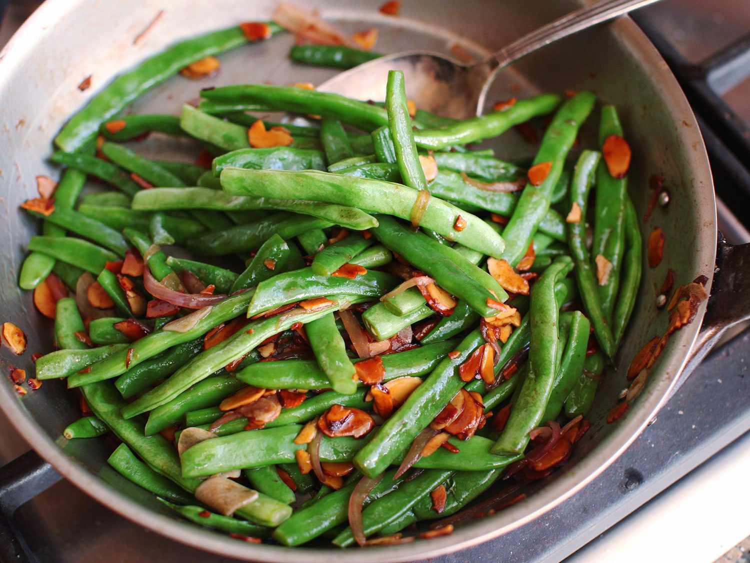 Closeup of green beans Amandine in a skillet.