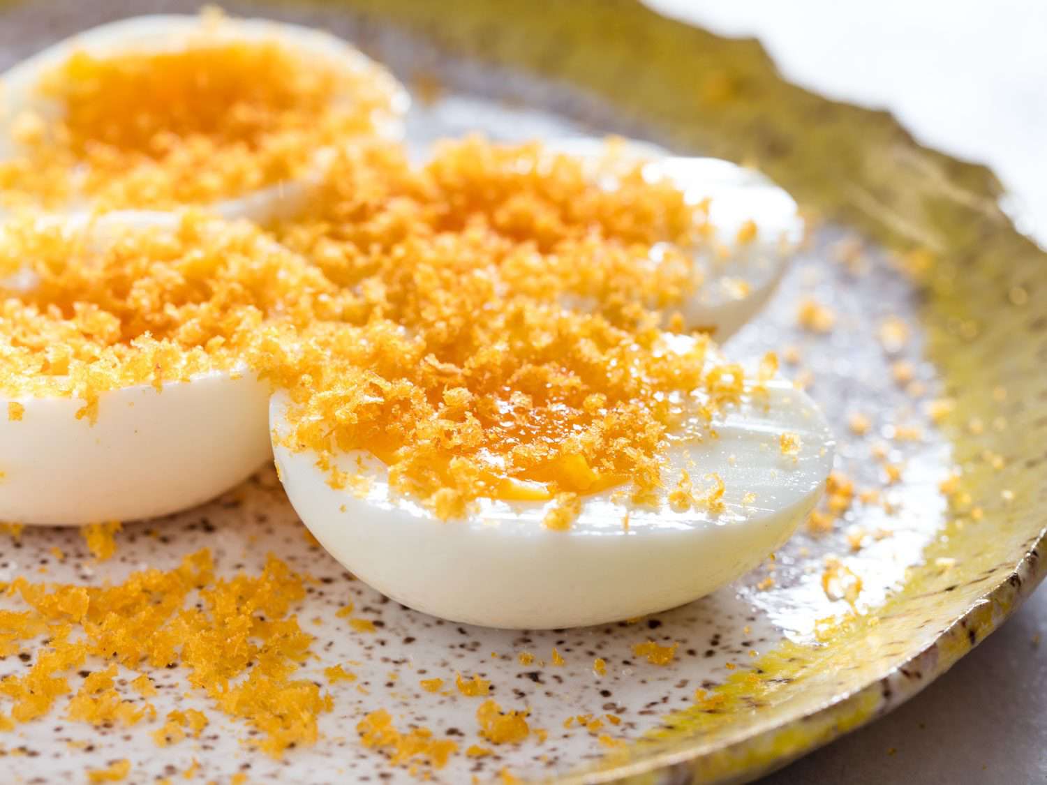 Soft-boiled eggs topped with grated bottarga.