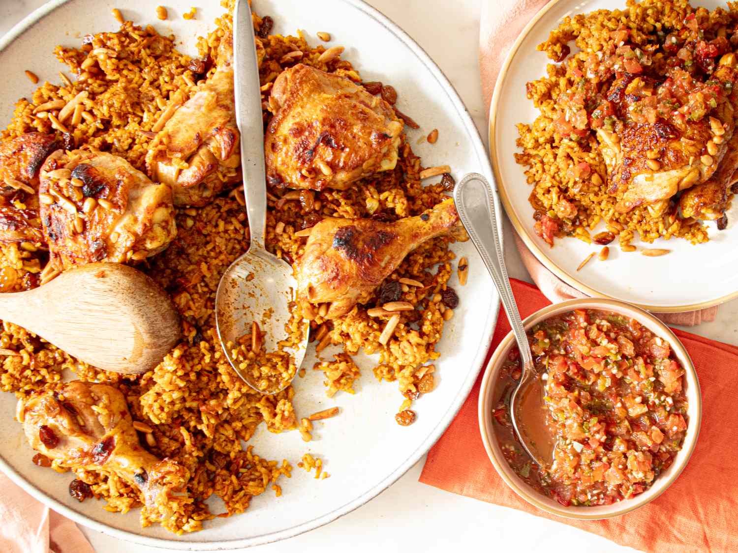 A serving of kabsa a Middle Eastern dish featuring rice and chicken presented with sauce on the side