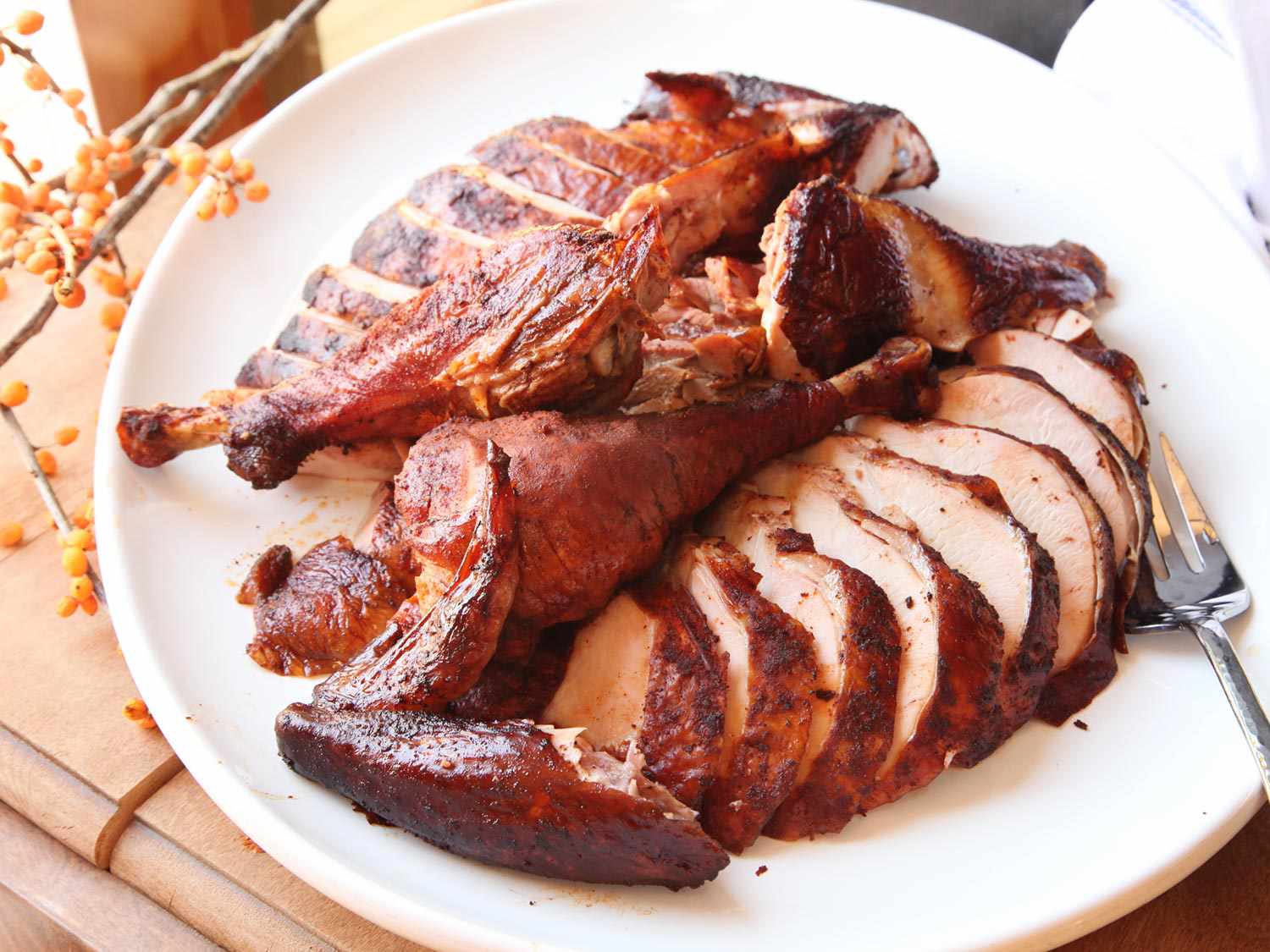 Smoked turkey, carved and arranged on a plate.
